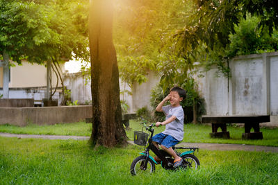 Woman riding bicycle in park