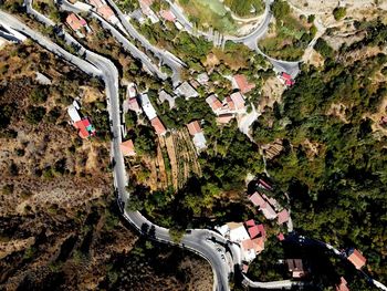 High angle view of road amidst trees and buildings in city