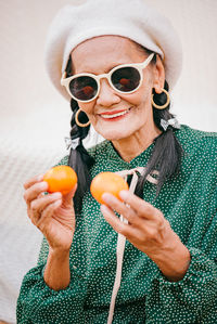 Portrait of a smiling young woman holding ice cream