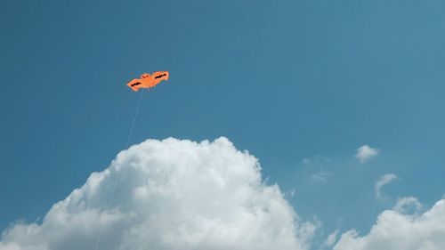 Low angle view of bird flying against blue sky