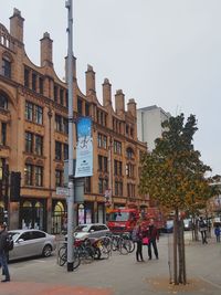 Cars on street against buildings in city