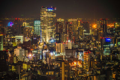 Illuminated modern buildings in city at night