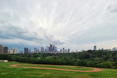 City skyline against cloudy sky