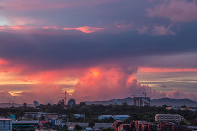 Townscape against dramatic sky during sunset