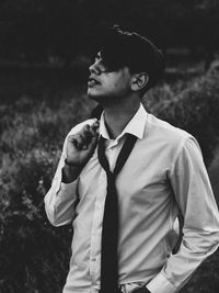 Young man wearing shirt and necktie while standing outdoors