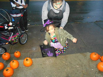 Full length of mother and daughter sitting on bicycle