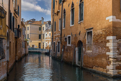 Canal amidst buildings in city