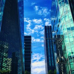 Low angle view of buildings against blue sky