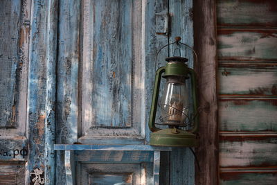 Old lantern hanging against wall