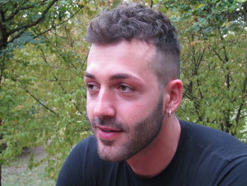 Portrait of young man against plants