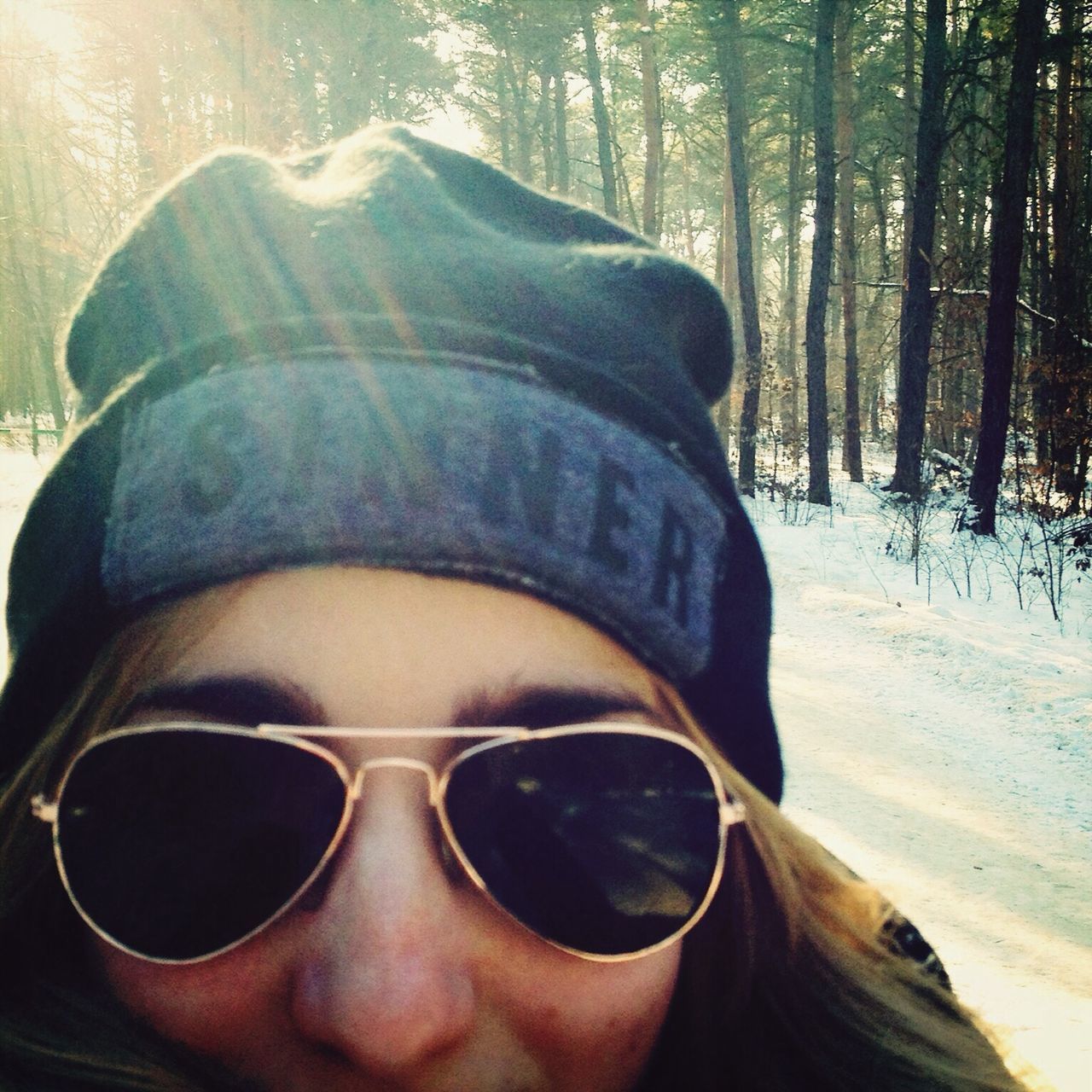 sunglasses, close-up, headshot, lifestyles, leisure activity, sunlight, portrait, young adult, tree, outdoors, focus on foreground, front view, day, nature, looking at camera, head and shoulders, part of