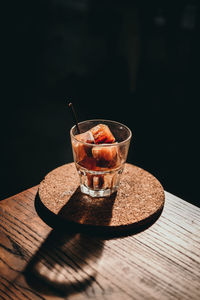 Close-up of drink in glass on table against black background