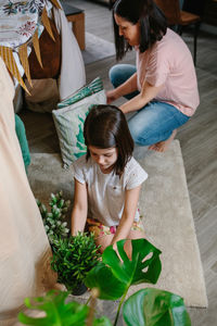 High angle view of friends sitting on floor