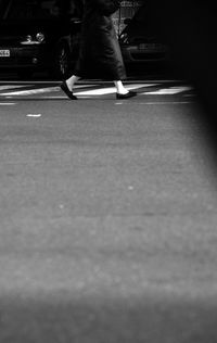 Low section of people walking on road