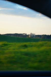 Scenic view of field against sky during sunset
