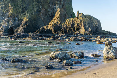 Rocks on beach against sky