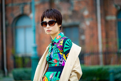 Young woman wearing sunglasses standing outdoors