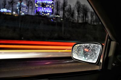 Close-up of traffic light on road at night