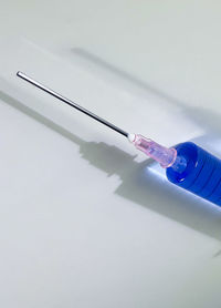 Close-up of hand holding water against white background