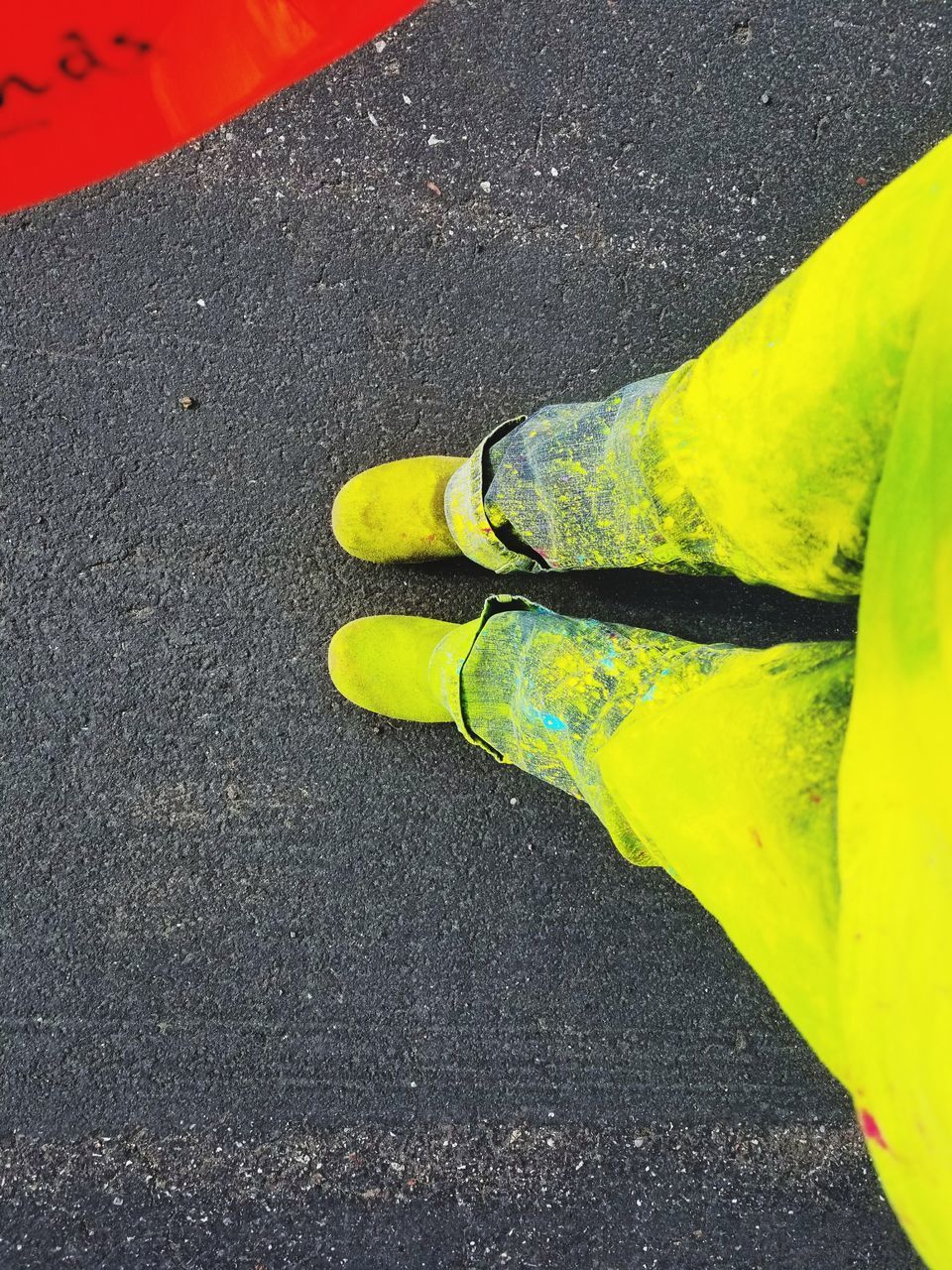 LOW SECTION OF MAN STANDING ON ROAD