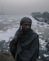 Portrait of man standing in snow