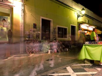 People in illuminated city at night