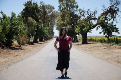 Full length of woman standing on road