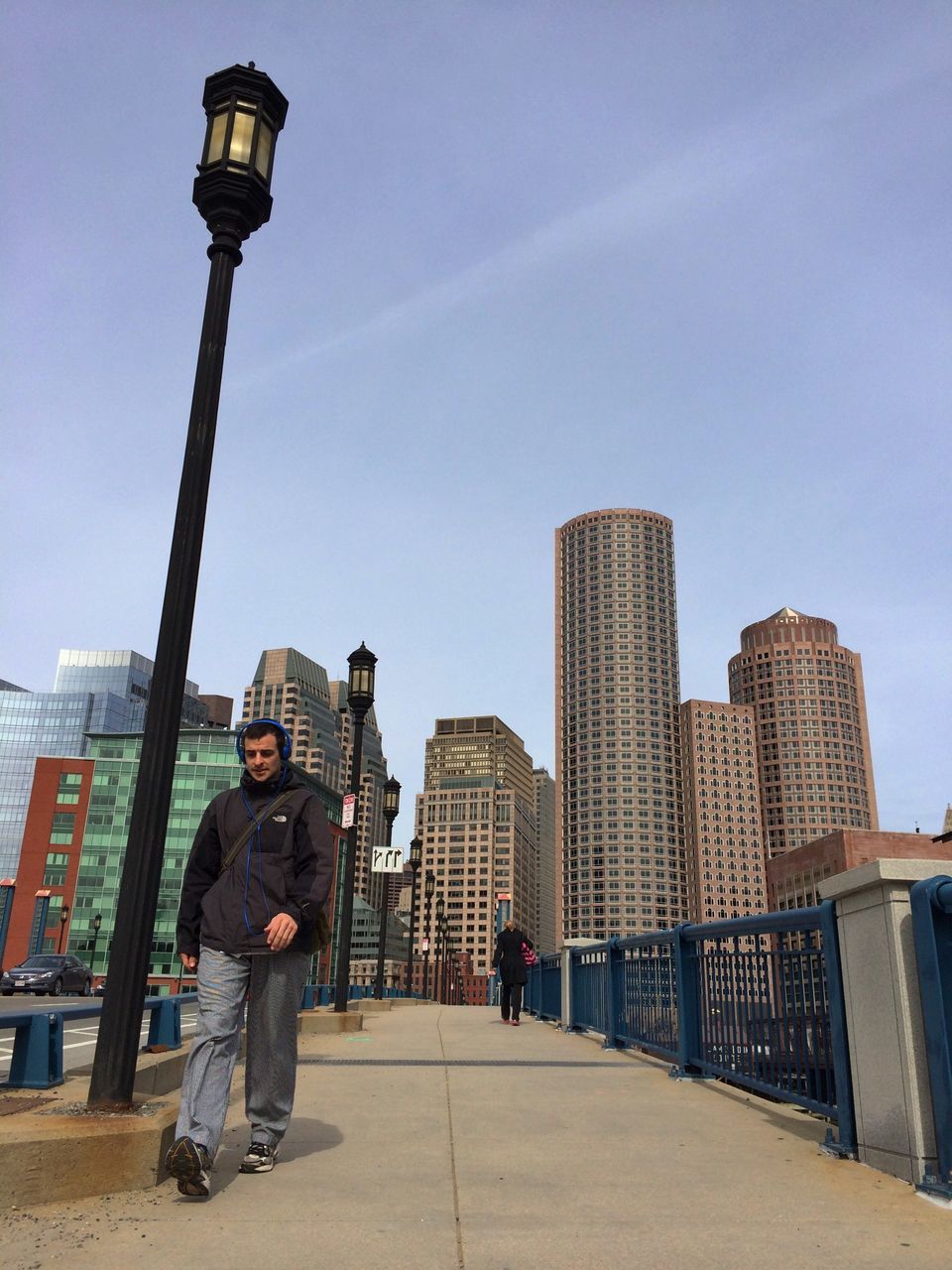 architecture, building exterior, built structure, full length, sky, lifestyles, city, men, rear view, railing, leisure activity, walking, casual clothing, street light, standing, city life, person