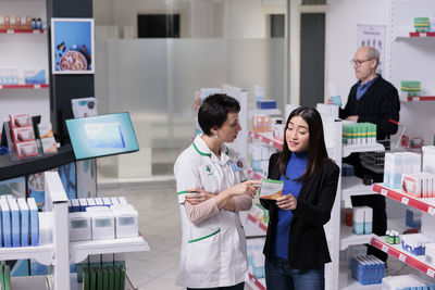 Portrait of young woman using digital tablet in office