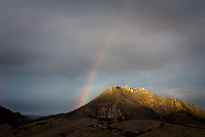 Rainbow over mountains against sky