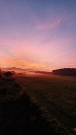 Scenic view of land against sky during sunset