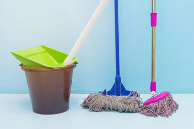 Mop and bucket against wall