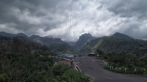 Scenic view of mountains against cloudy sky