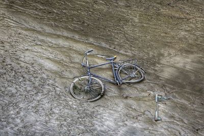 High angle view of abandoned bicycle in mud