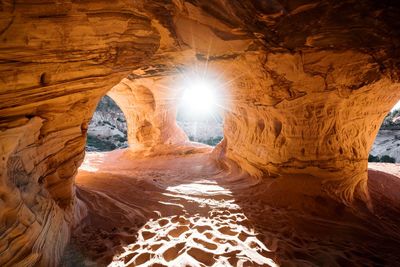 Sunlight streaming through rocks in water