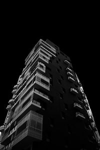 Low angle view of illuminated building against sky at night