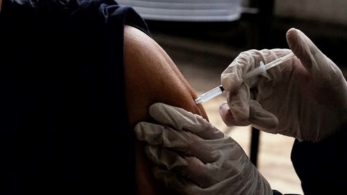 A health officer gives a covid-19 booster vaccine to a resident in tangerang,indonesia