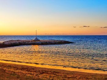 Scenic view of sea against clear sky during sunset