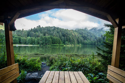 Scenic view of lake in forest against sky