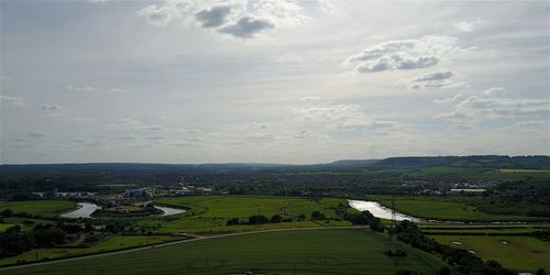 High angle view of a field against cloudy sky