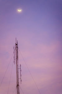 Low angle view of silhouette electricity pylon against sky during sunset