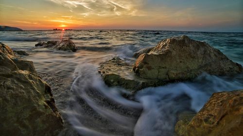 Scenic view of sea against sky during sunset