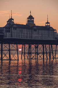 Rising sun underneath eastbourne pier