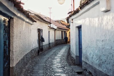 Cobbled footpath amidst houses