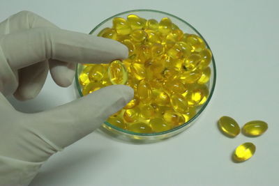 Cropped image of person holding yellow candies