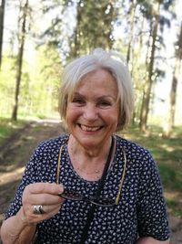 Portrait of a smiling young woman in forest