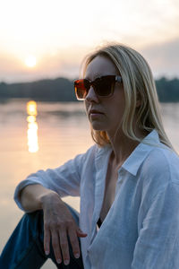 Portrait of a woman by the lake at sunset.