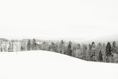 Scenic view of snow covered landscape against clear sky