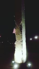 Close-up of illuminated built structure against sky at night