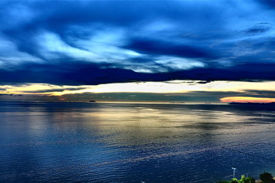 Scenic view of beach against dramatic sky